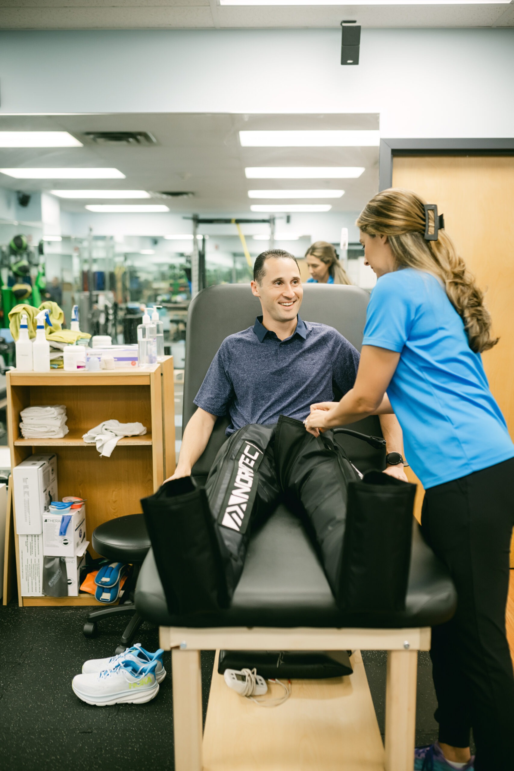 Athlete using recovery technology during sports performance therapy session in Farmingdale
