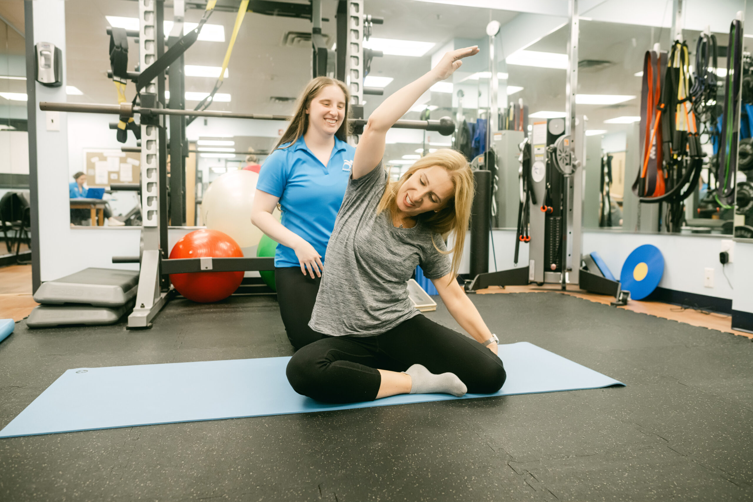 Physical therapist performing movement assessment with athlete in Farmingdale physical therapy clinic