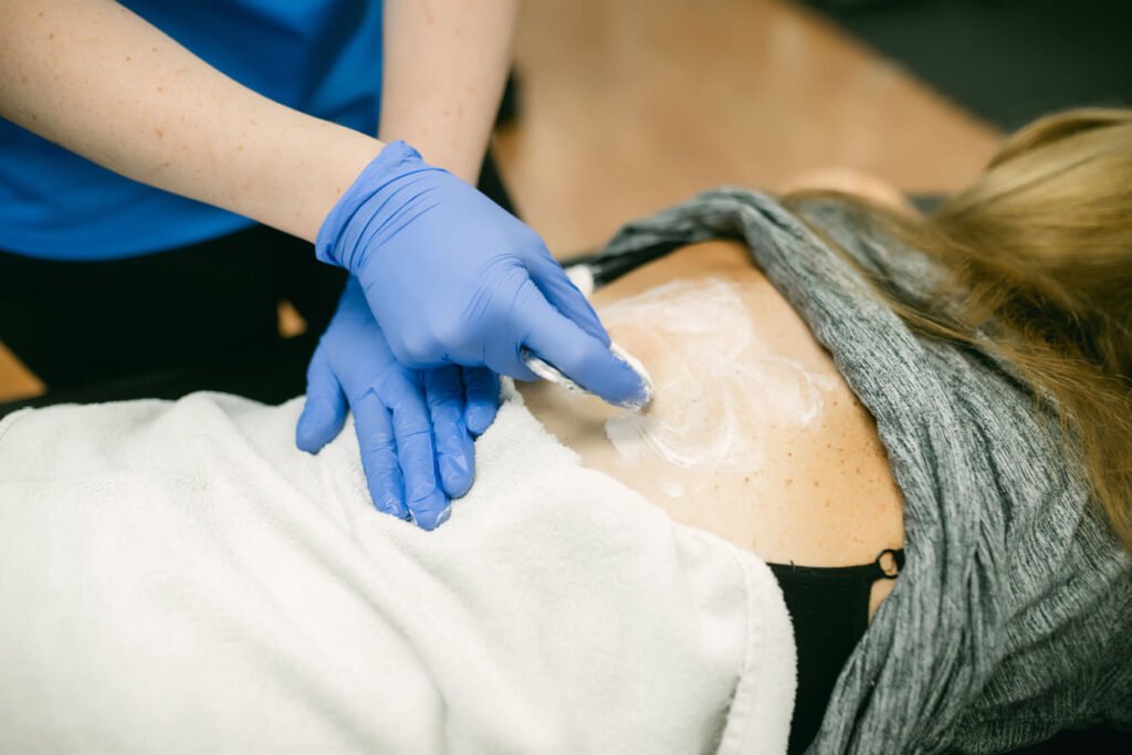 Woman being treated for upper back pain after shoveling snow — In Motion Physical Therapy Farmingdale NY