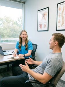Patient working with a physical therapist at a performance physical therapy clinic in Farmingdale discussing evaluation and treatment goals