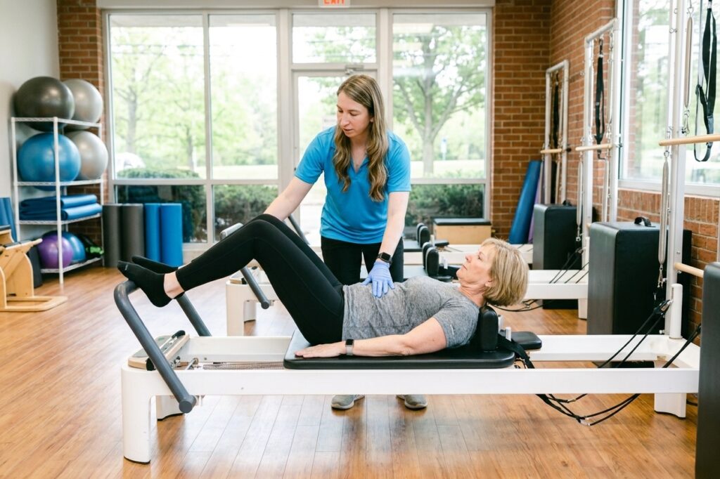 Patient working with a provider at a physical therapy and Pilates clinic in Farmingdale, NY during a core strengthening and recovery exercise