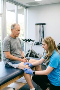 Patient performing Pilates-based rehabilitation with a physical therapist at a performance physical therapy clinic in Farmingdale, NY