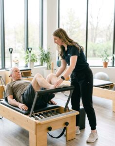Physical therapist performing manual therapy on a patient's knee at a physical therapy clinic in Farmingdale, NY
