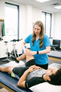 Patient working with a provider at a performance physical therapy clinic in Farmingdale, NY during a manual therapy treatment for knee pain